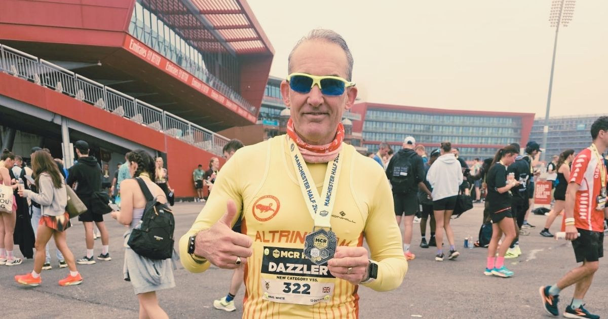 Masters runner in his 40s running at fast pace on the track, illustrating how to maintain speed after 40