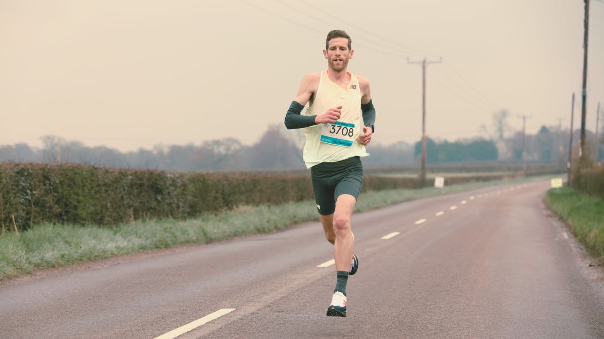 Runner checking weekly training plan from their online coach on a phone